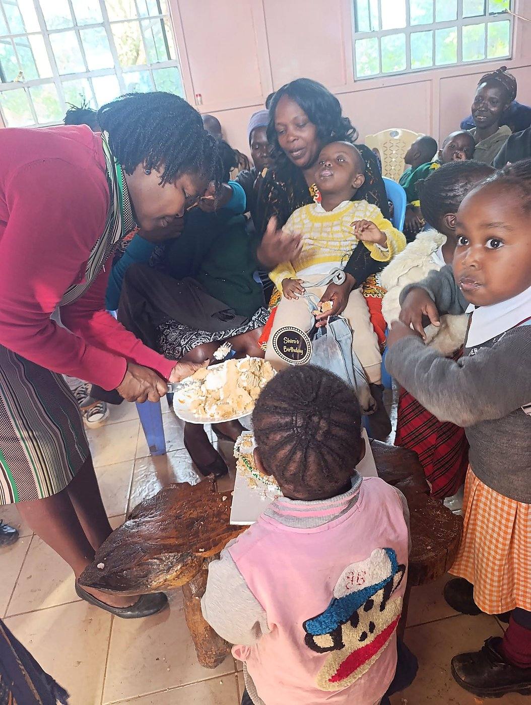 Serving a hot meal to children at a GCIG event